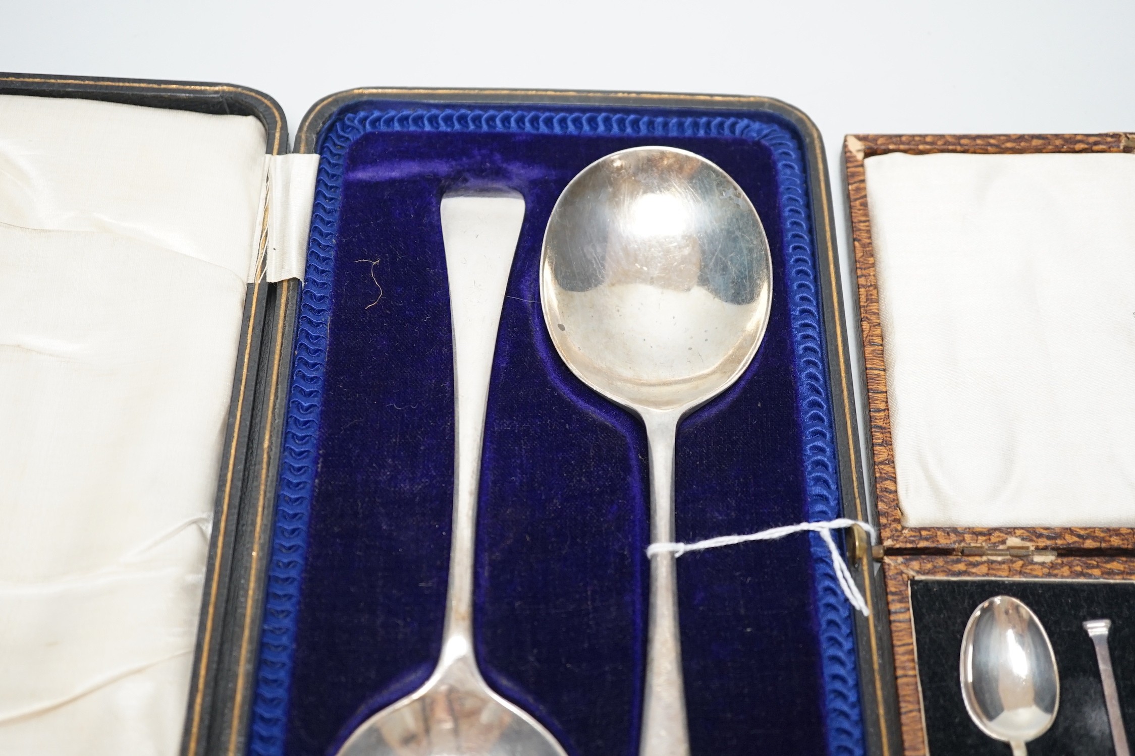 A set of six George V silver seal top coffee spoon, cased, and a pair of George V silver old English pattern fruit spoons, Sheffield, 1916, cased.